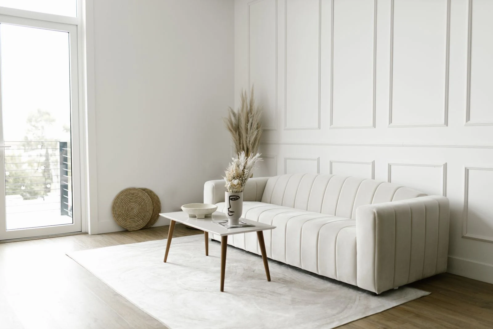 Photographed living room with a cream sofa and paneled walls